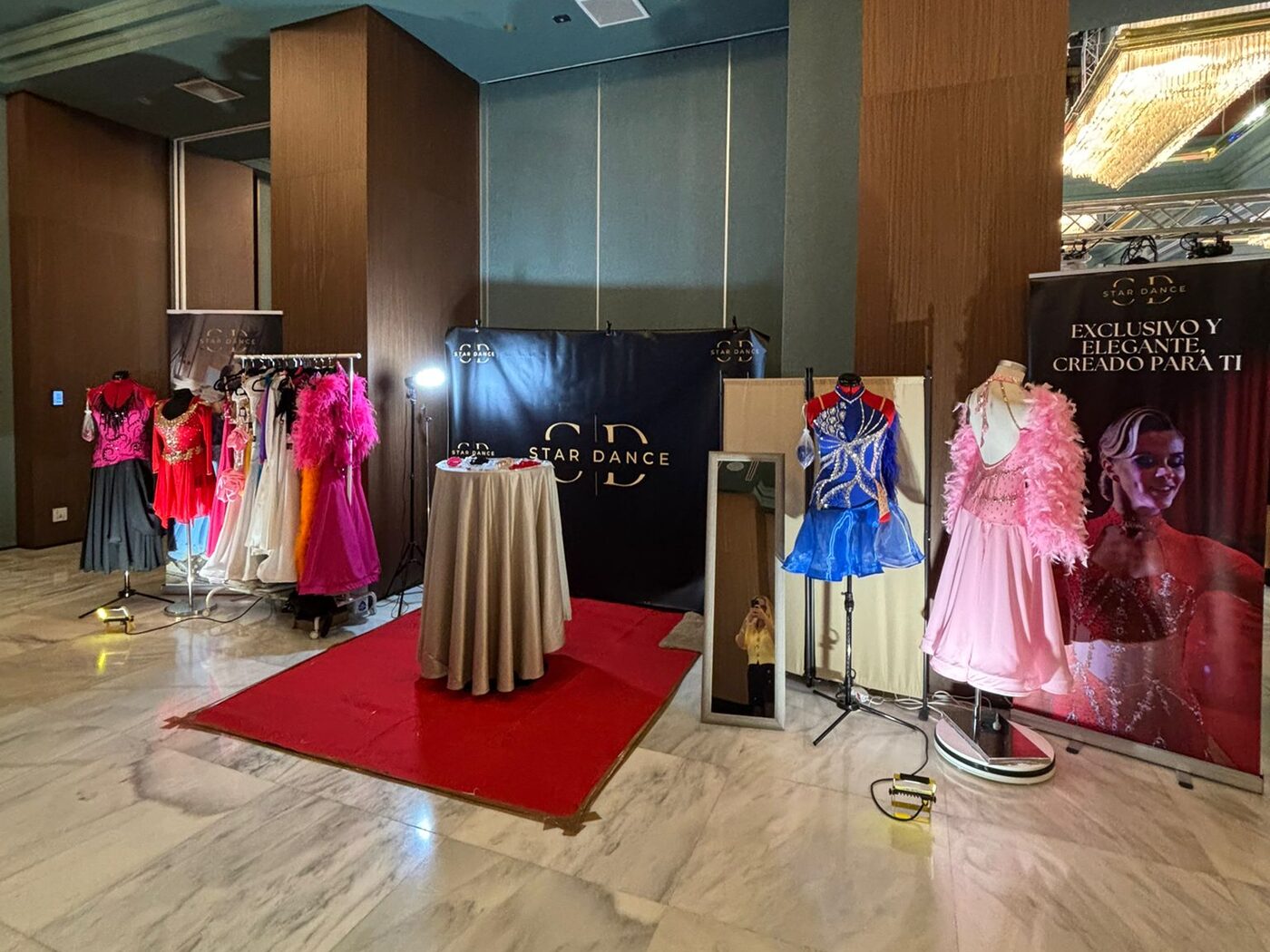 The Star Dance stand at a competition, with Ballroom and Latin dresses on display
